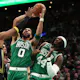 Jayson Tatum of the Boston Celtics takes a shot against Kevon Looney of the Golden State Warriors at TD Garden on Jan. 19, 2023 in Boston, Massachusetts.