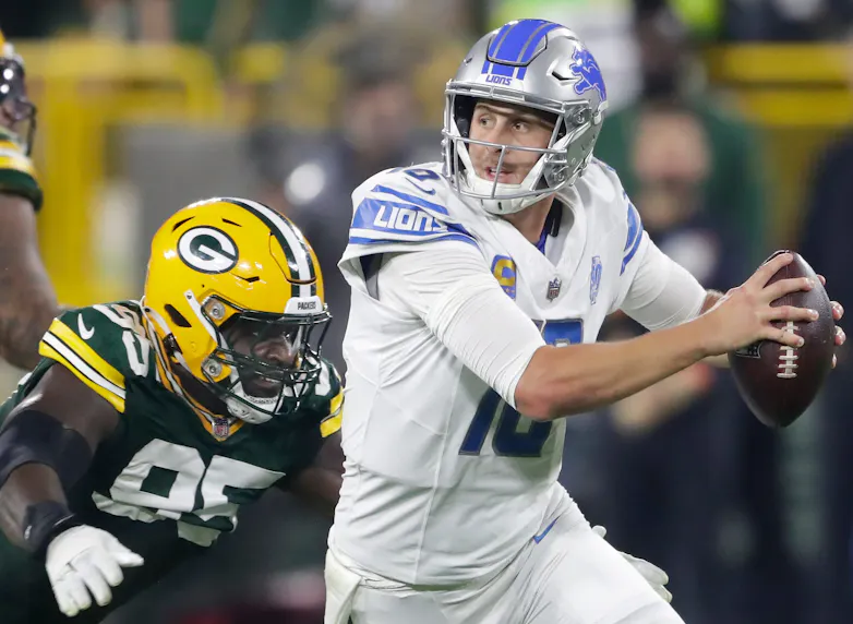 Green Bay Packers defensive tackle Devonte Wyatt (95) chases Detroit Lions quarterback Jared Goff (16) as we offer our best NFL Week 9 player prop picks and odds for Sunday.