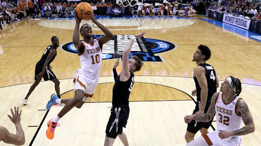 Sir'Jabari Rice of the Texas Longhorns drives to the basket against Adam Kunkel of the Xavier Musketeers during the Sweet 16 round of the NCAA Men's Basketball Tournament at T-Mobile Center on Mar. 24, 2023 in Kansas City, Missouri.