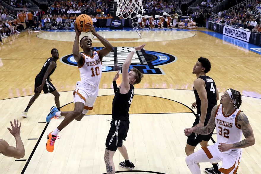 Sir'Jabari Rice of the Texas Longhorns drives to the basket against Adam Kunkel of the Xavier Musketeers during the Sweet 16 round of the NCAA Men's Basketball Tournament at T-Mobile Center on Mar. 24, 2023 in Kansas City, Missouri.