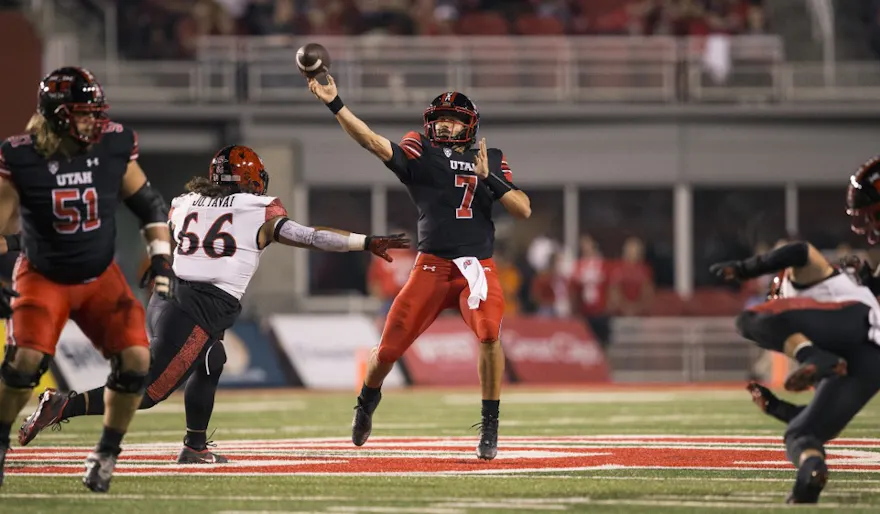 Cameron Rising of the Utah Utes throws under pressure from Jonah Tavai of the San Diego State Aztecs during the first half of their game on September 17, 2022 at Rice Eccles Stadium in Salt Lake City, Utah.