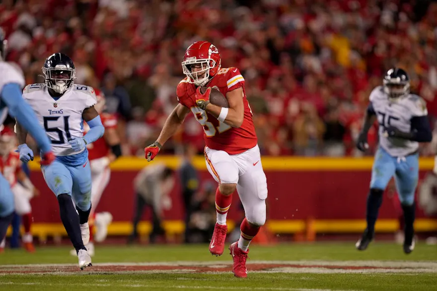 Travis Kelce of the Kansas City Chiefs runs with the ball after a reception. He's featured in our 57 prop bets for Super Bowl 57