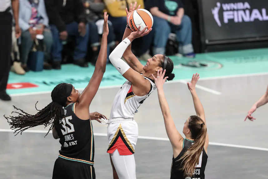 Las Vegas Aces forward A'ja Wilson (22) shoots over New York Liberty forward Jonquel Jones (35), as we offer our best Liberty vs. Aces prediction and expert pick for Saturday's WNBA matchup on ABC at Michelob ULTRA Arena in Paradise, Nev.