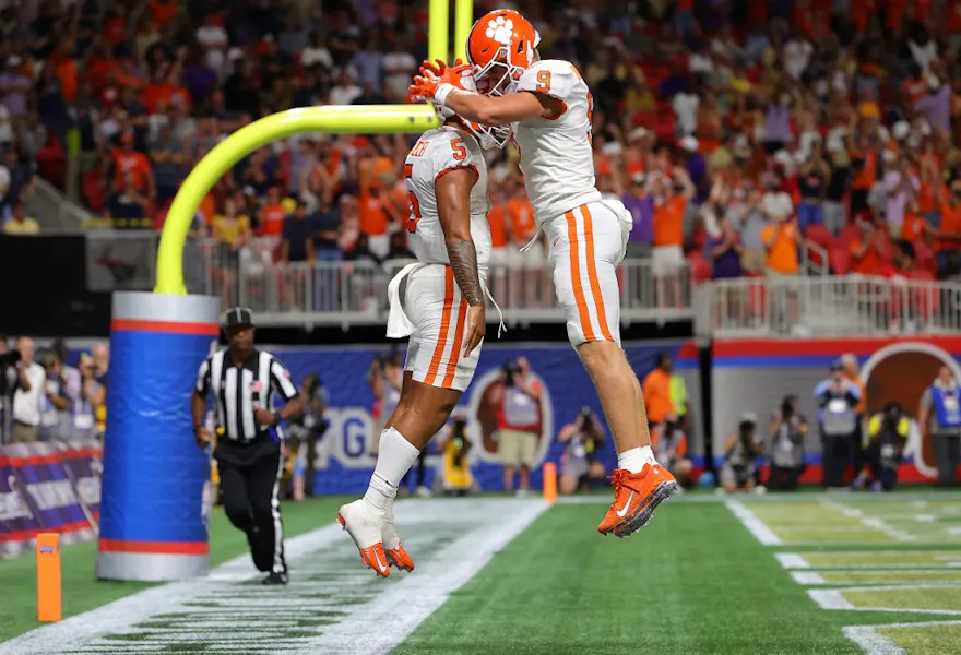 DJ Uiagalelei of the Clemson Tigers reacts with Jake Briningstool after rushing for a touchdown against the Georgia Tech Yellow Jackets.