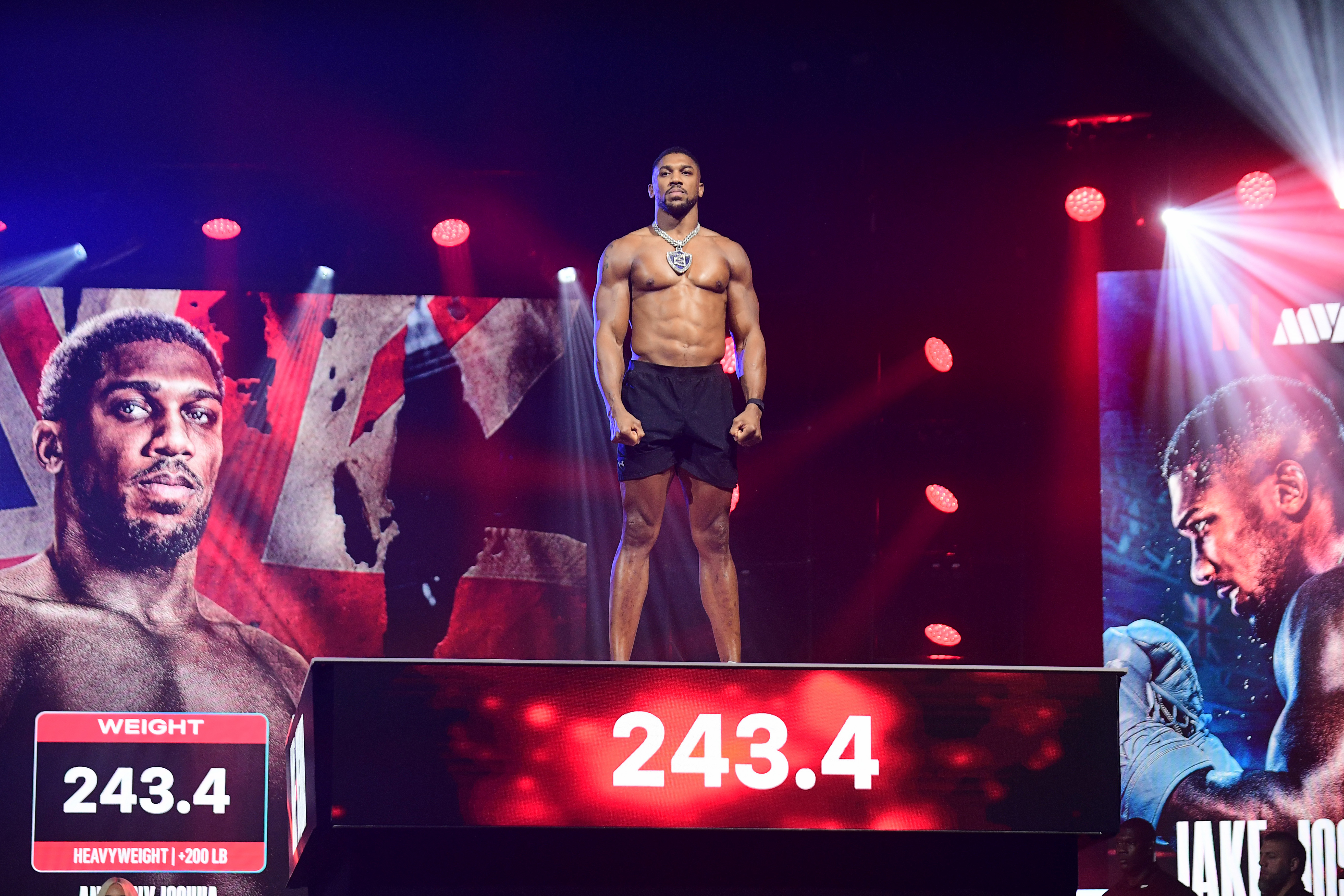 Anthony Joshua stands on the platform as we look at fighters giving their opinion of tonight's Paul-Joshua fight.