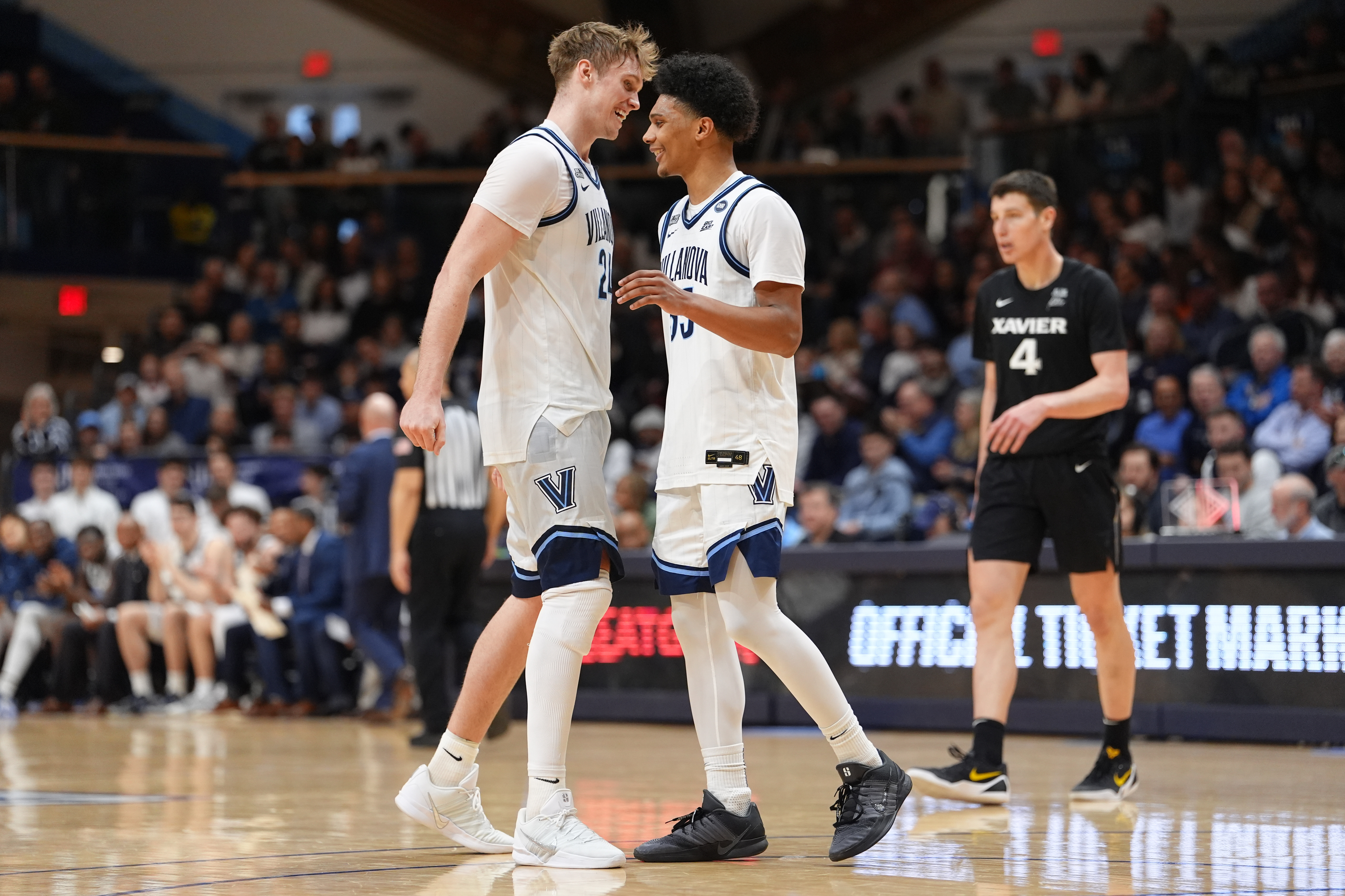 Villanova Wildcats forward Duke Brennan (24) and guard Acaden Lewis (55), featured in our Utah State vs. Villanova prediction, react during a game against Xavier.
