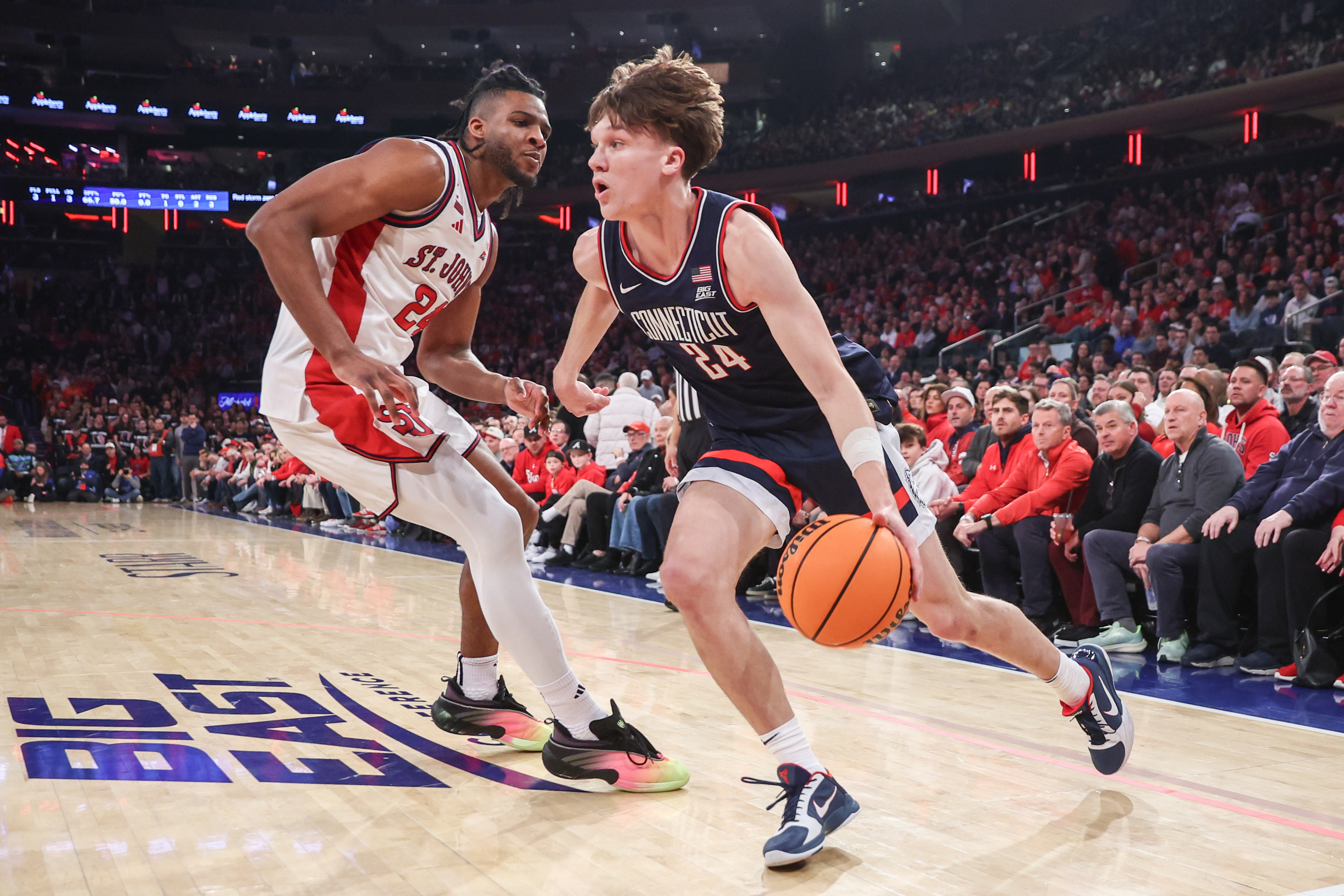 UConn's Braylon Mullins (24) leads the Huskies against St. John's in the biggest game of our college basketball predictions today. 
