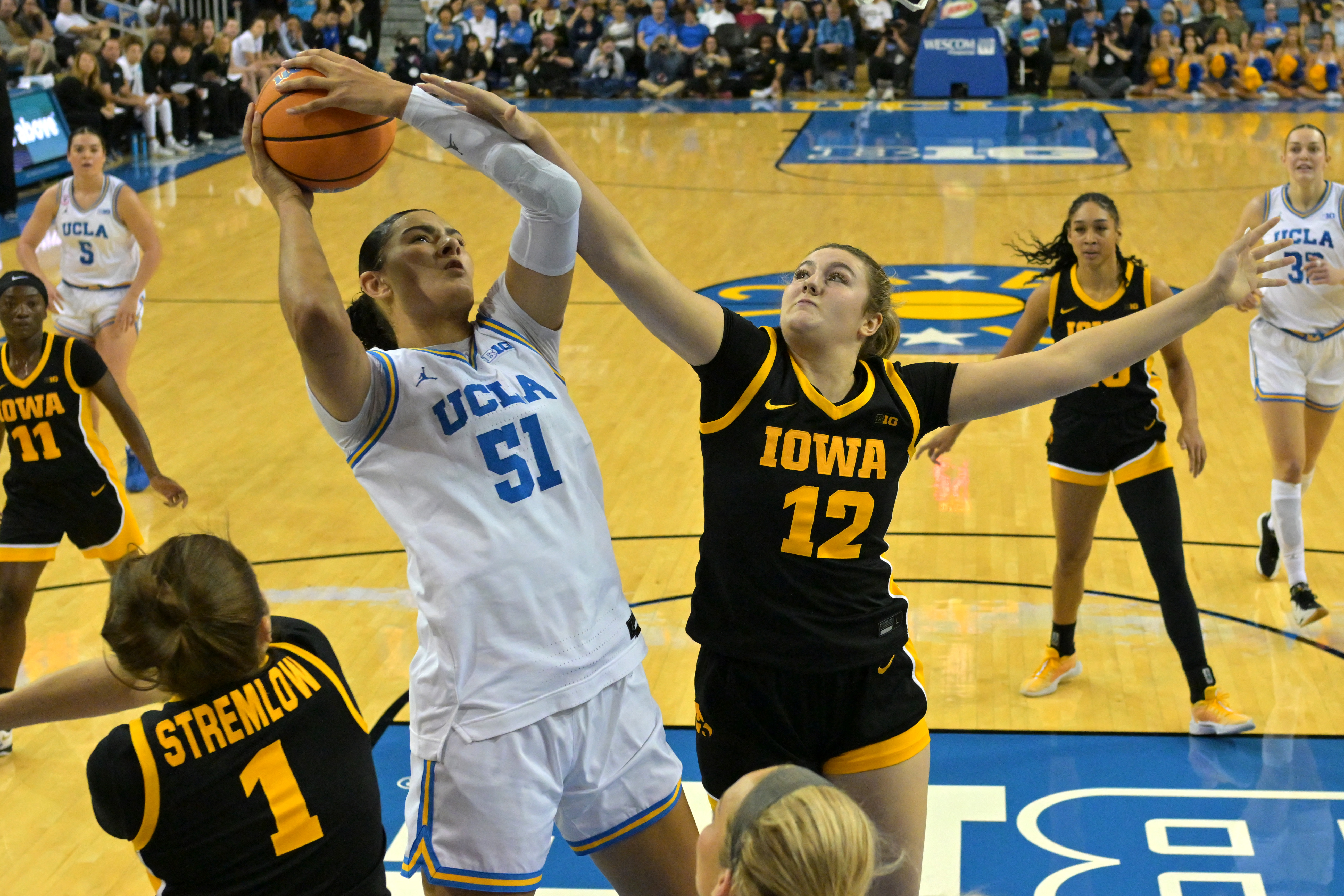 UCLA's Lauren Betts (51) makes the Bruins a popular pick for women's March Madness predictions. 