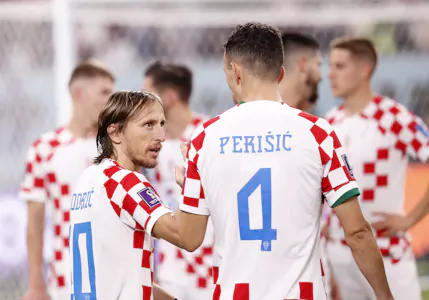 Croatia midfielder Luka Modric reacts with forward Ivan Perisic after winning the third place match against Morocco during the 2022 World Cup  as Gary Pearson looks at the best props for Saturday's Euro 2024 Group B match between Spain and Croatia. 