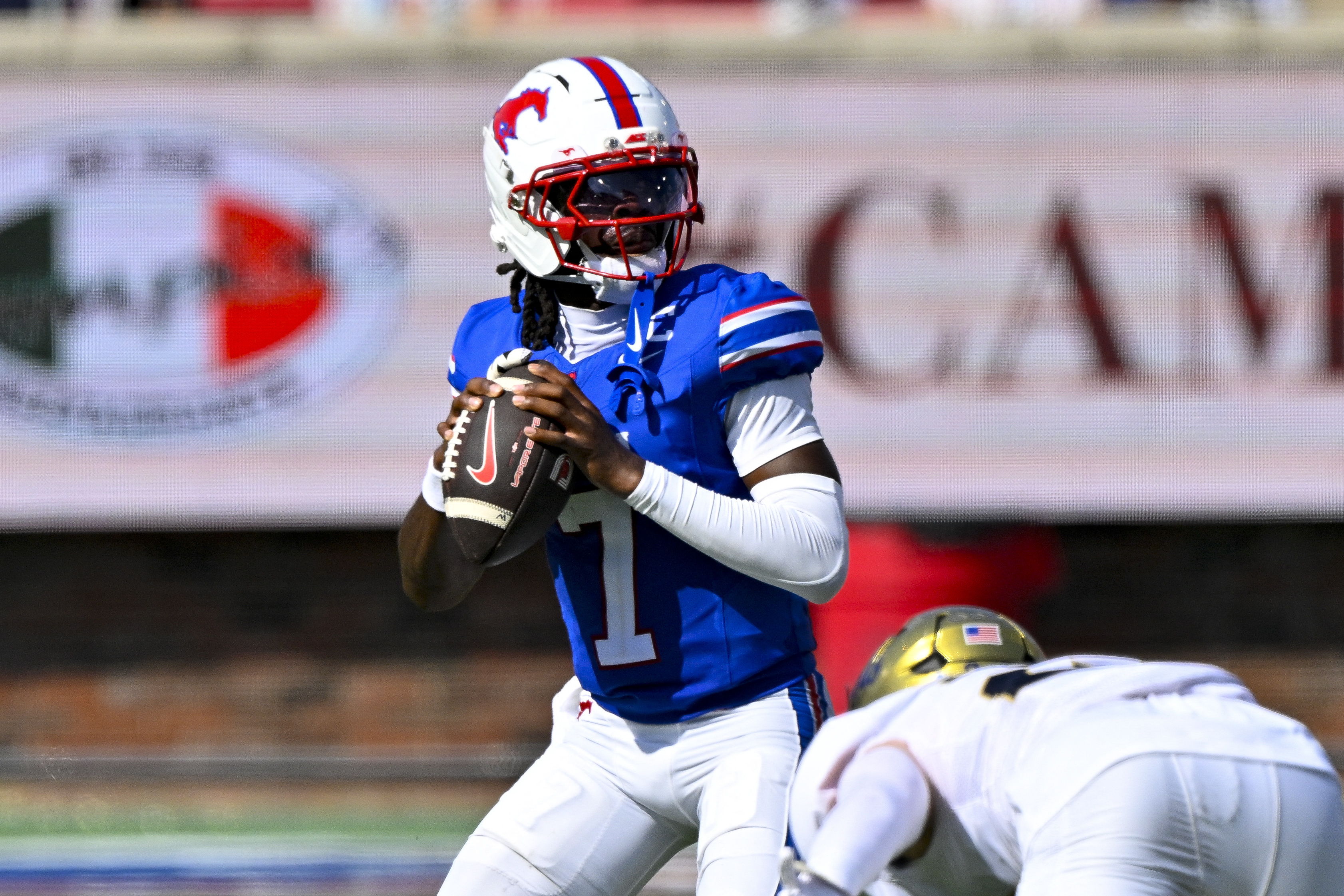 SMU Mustangs quarterback Kevin Jennings (7) drops back to pass as he is featured in our SMU vs. Louisville prediction.