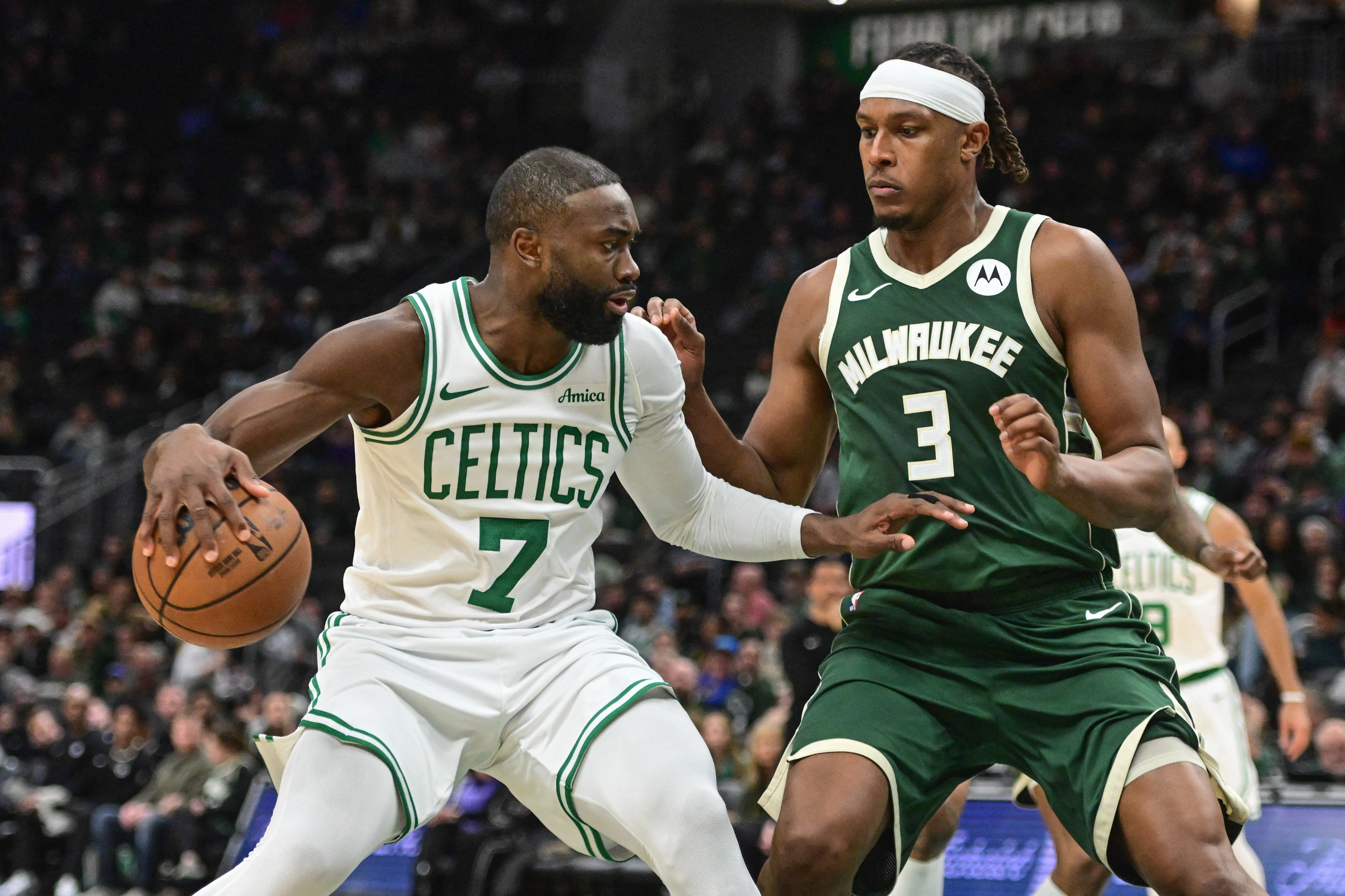 Boston Celtics forward Jaylen Brown (7) looks for a shot against Milwaukee Bucks center Myles Turner (3) as we offer our Bucks vs. Celtics player props today.