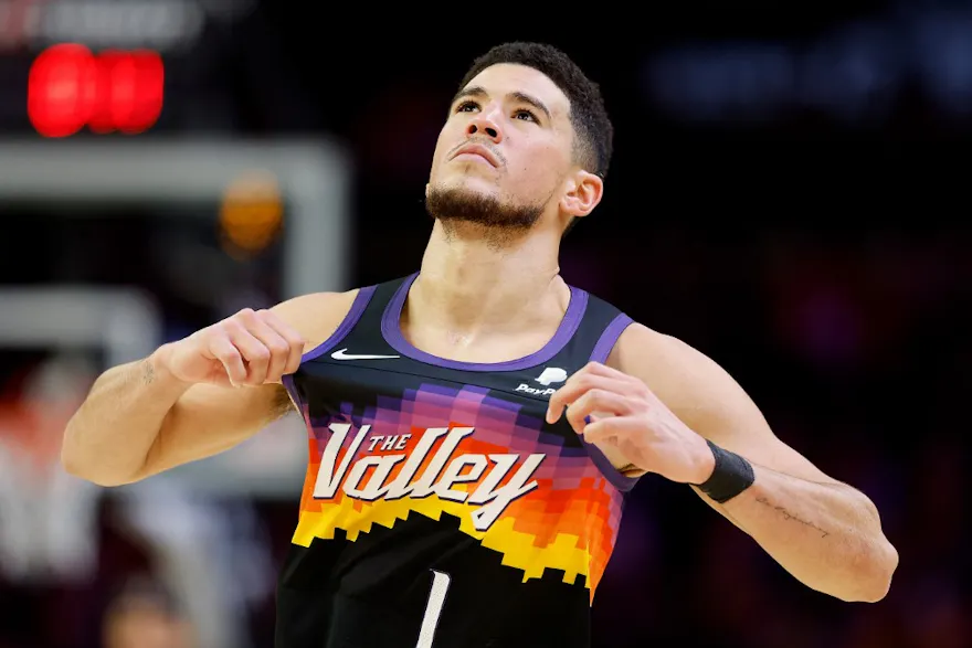 Devin Booker of the Phoenix Suns adjusts his jersey during the second half against the Brooklyn Nets, and we offer our top Suns vs. Mavericks player props based on the best NBA odds.