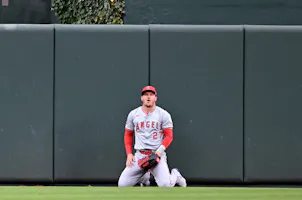 Mike Trout of the Los Angeles Angels reacts after a home run by Cedric Mullins of the Baltimore Orioles, and we examine whether it's time to stop betting on Mike Trout to win AL MVP with a look at the best MLB odds.,