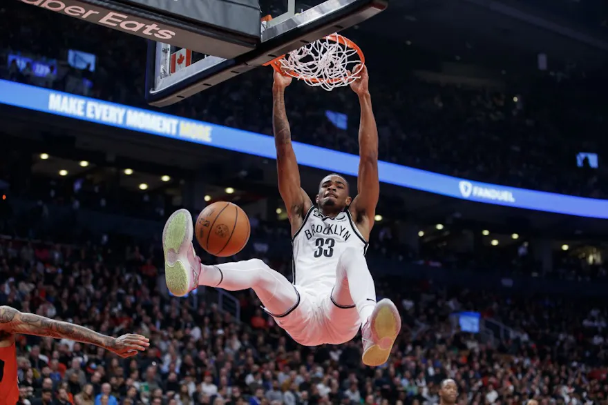 Nic Claxton of the Brooklyn Nets dunks on the net during the first half of their NBA game against the Toronto Raptors at Scotiabank Arena on November 23, 2022 in Toronto, Canada.