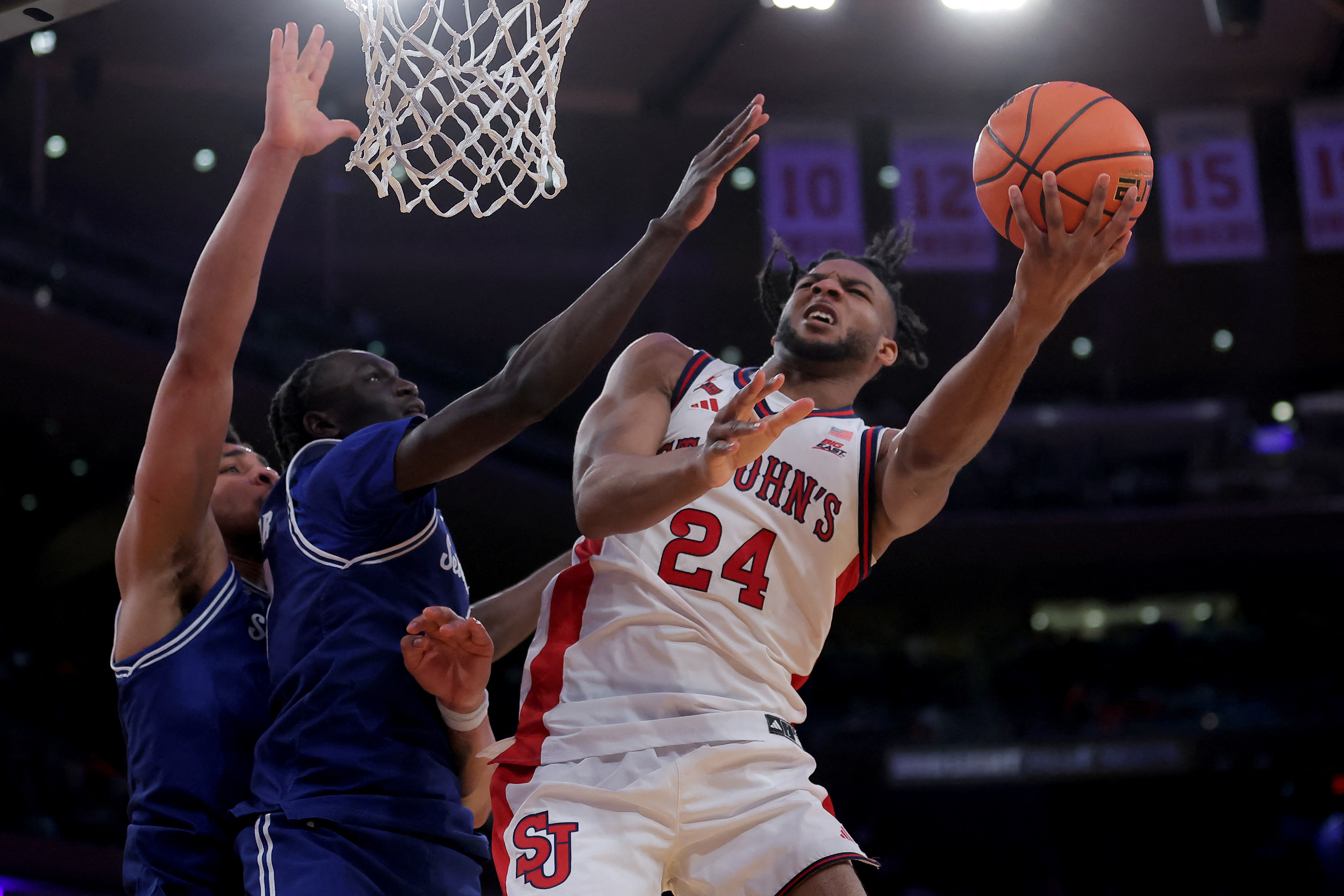 St. John's Red Storm forward Zuby Ejiofor (24) drives to the basket as we break down our Northern Iowa vs St Johns prediction.