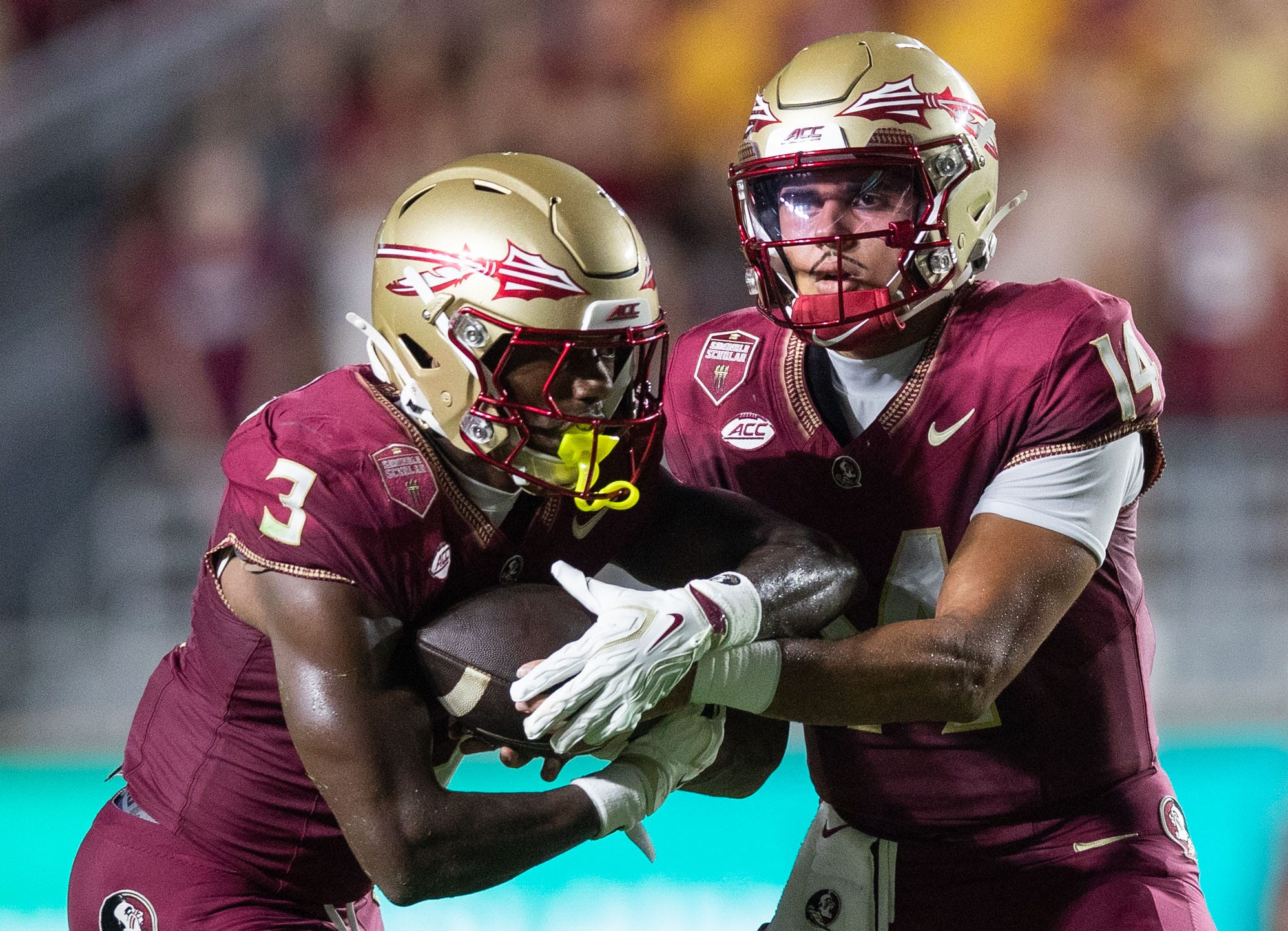 Florida State quarterback Ashton Daniels (14) hands the ball off to running back Samuel Singleton Jr. (3) as we break down our Virginia vs. Florida State prediction.