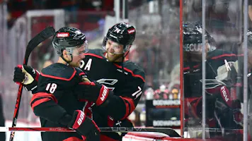 Jaccob Slavin and Jack Drury celebrate after a win against the New York Islanders in Game 5 as we make our expert predictions for Game 1 of the Carolina Hurricanes vs. New York Rangers second-round series. 