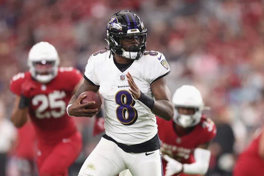 Lamar Jackson rushes the football ahead of our Week 14 NFL predictions for Rams vs. Ravens 