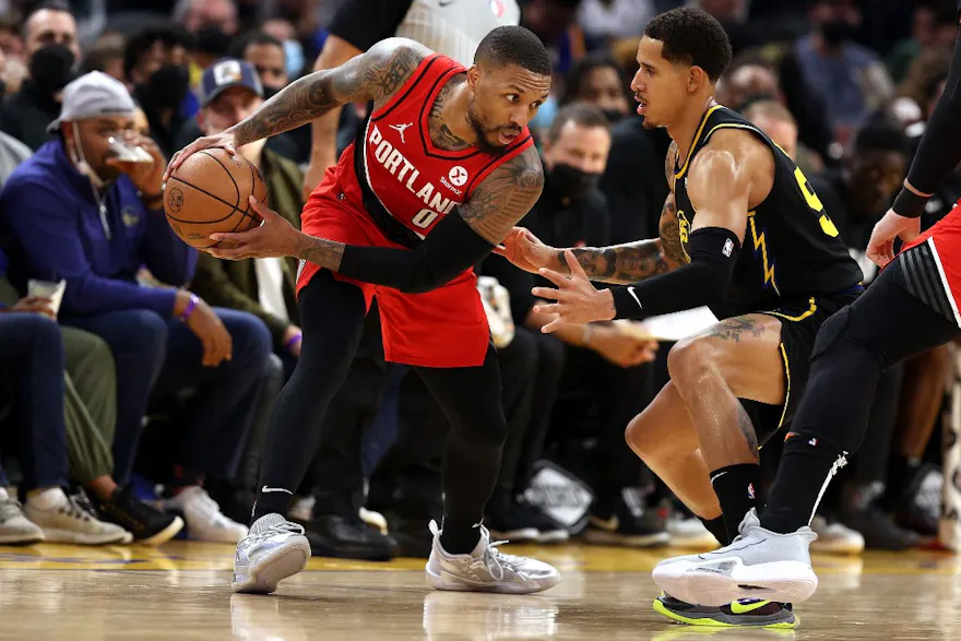 Damian Lillard of the Portland Trail Blazers handles the ball against Juan Toscano-Anderson of the Golden State Warriors. 