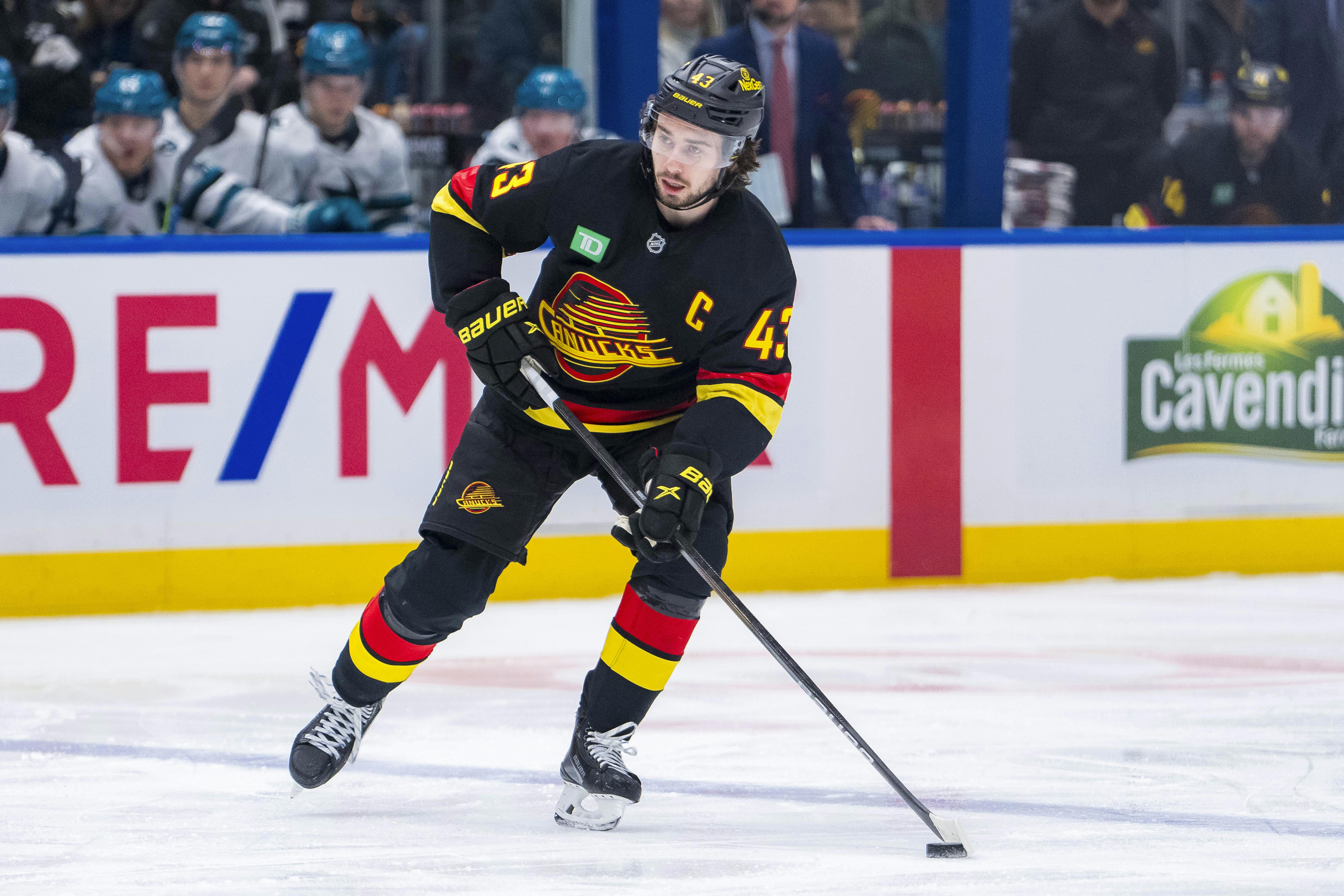 Vancouver Canucks defenseman Quinn Hughes handles the puck against the San Jose Sharks as we analyze the 2025 Norris Trophy odds. 