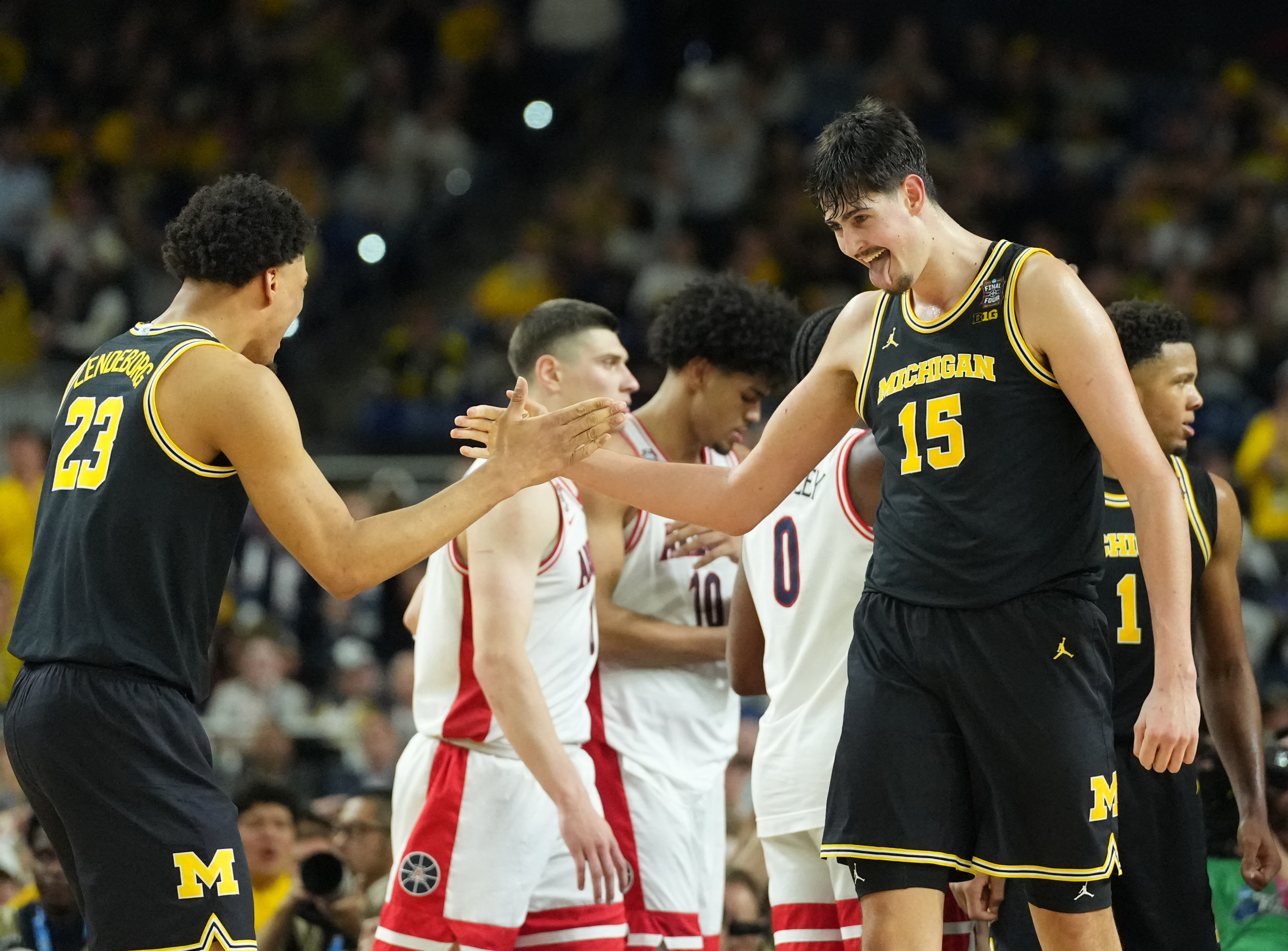 Yaxel Lendeborg (23) and Aday Mara (15) have Michigan favored by the March Madness odds ahead of its championship against UConn. 
