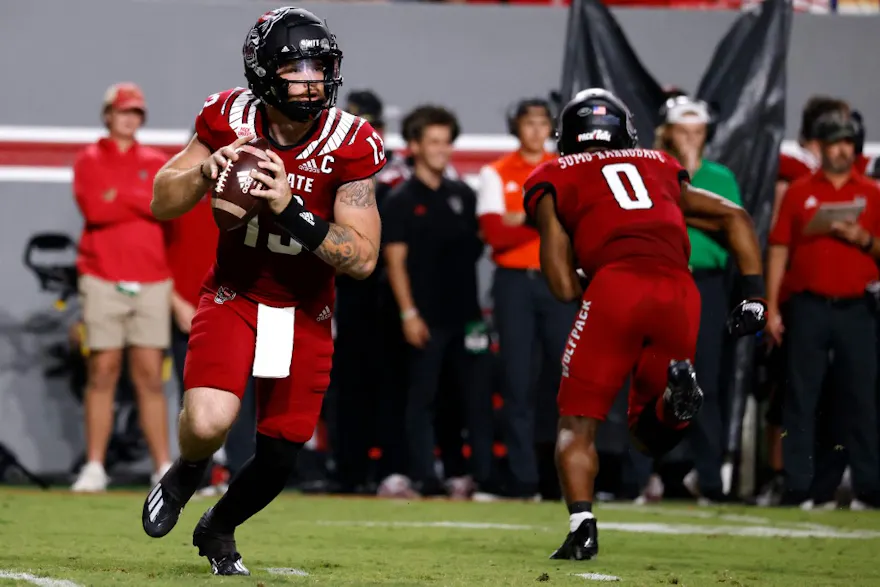 Devin Leary of the North Carolina State Wolfpack looks to pass during the first half of their game against the Connecticut Huskies at Carter-Finley Stadium on September 24, 2022 in Raleigh, North Carolina.