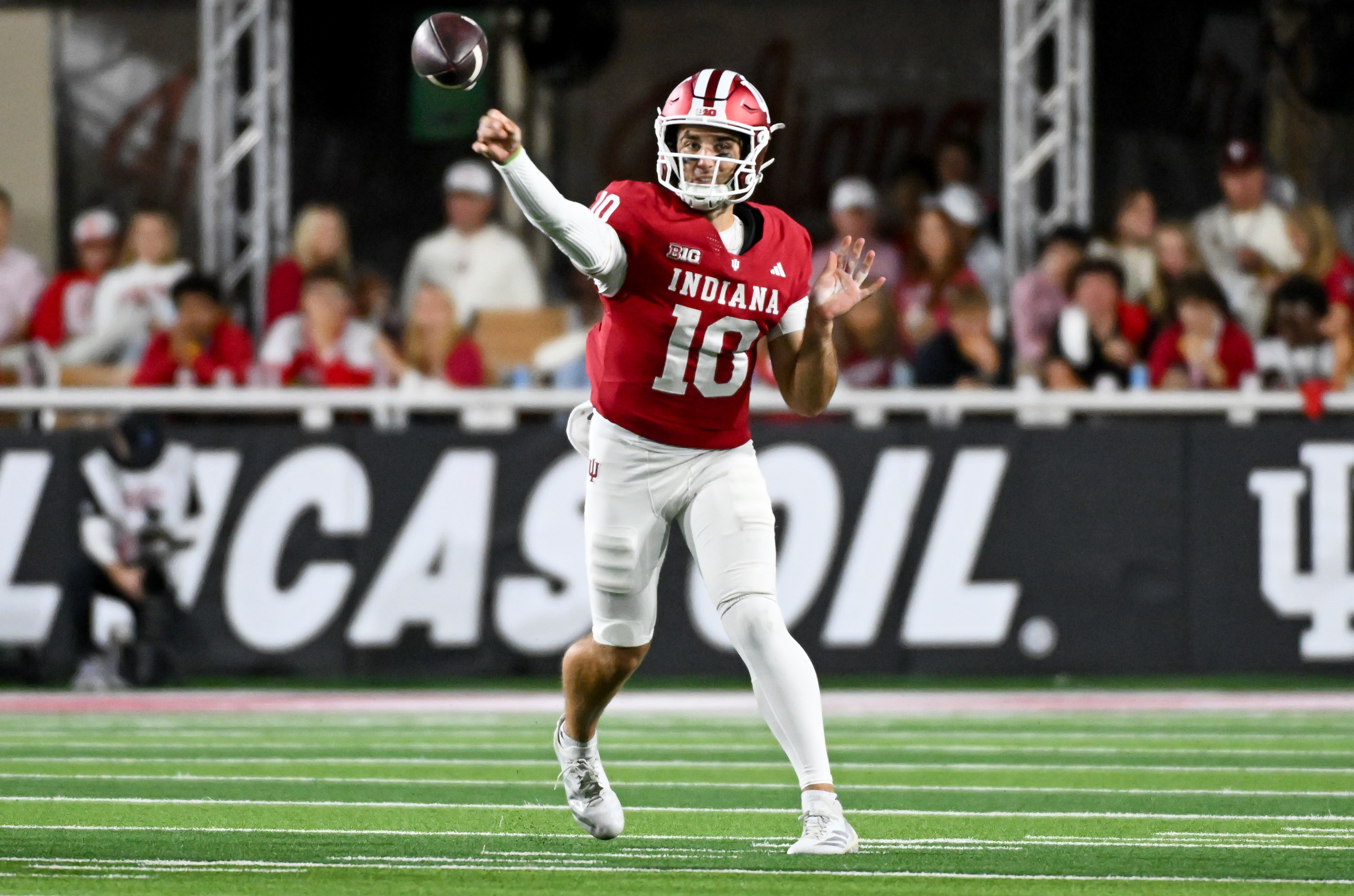 Pictured: Hoosiers quarterback Josh Hoover throwing a pass as we break down our Indiana vs. Rutgers Prediction. Photo by Robert Goddin-Imagn Images.