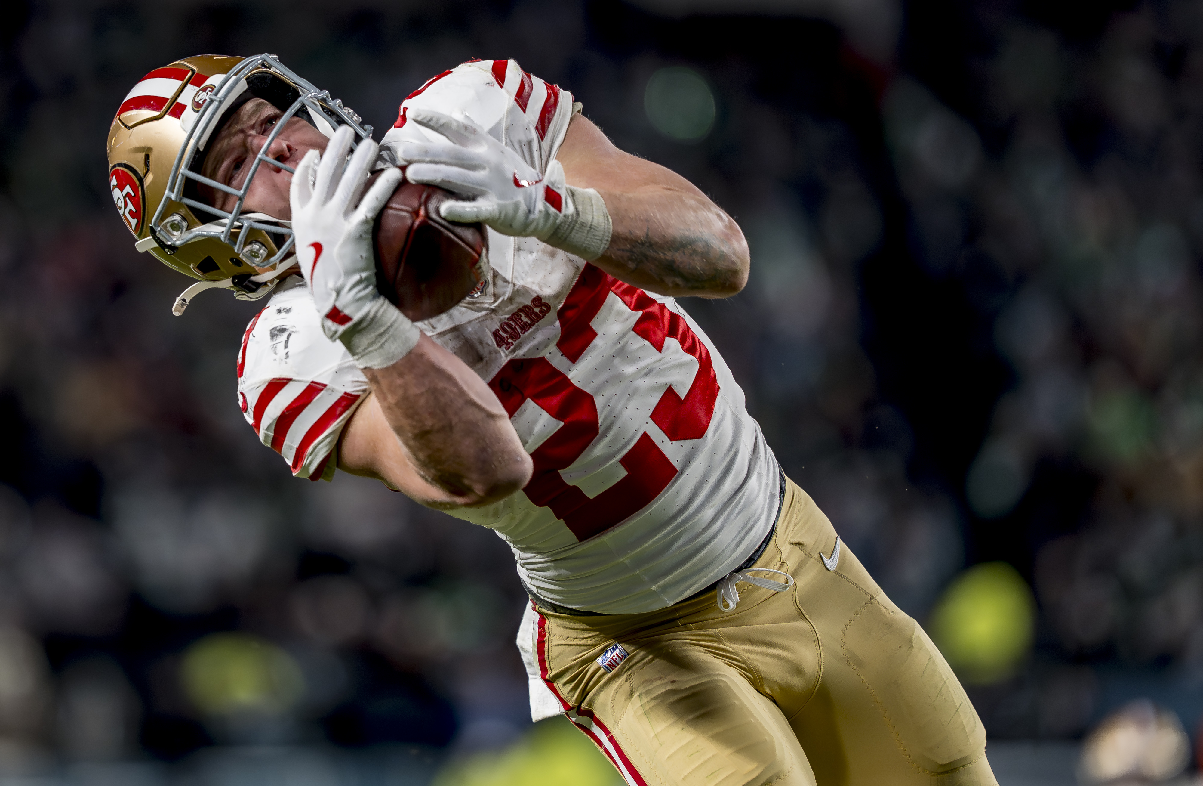 San Francisco 49ers running back Christian McCaffrey (23), seen here catching a touchdown pass, is featured in our 49ers vs. Seahawks same-game parlay for the NFL Divisional Round.