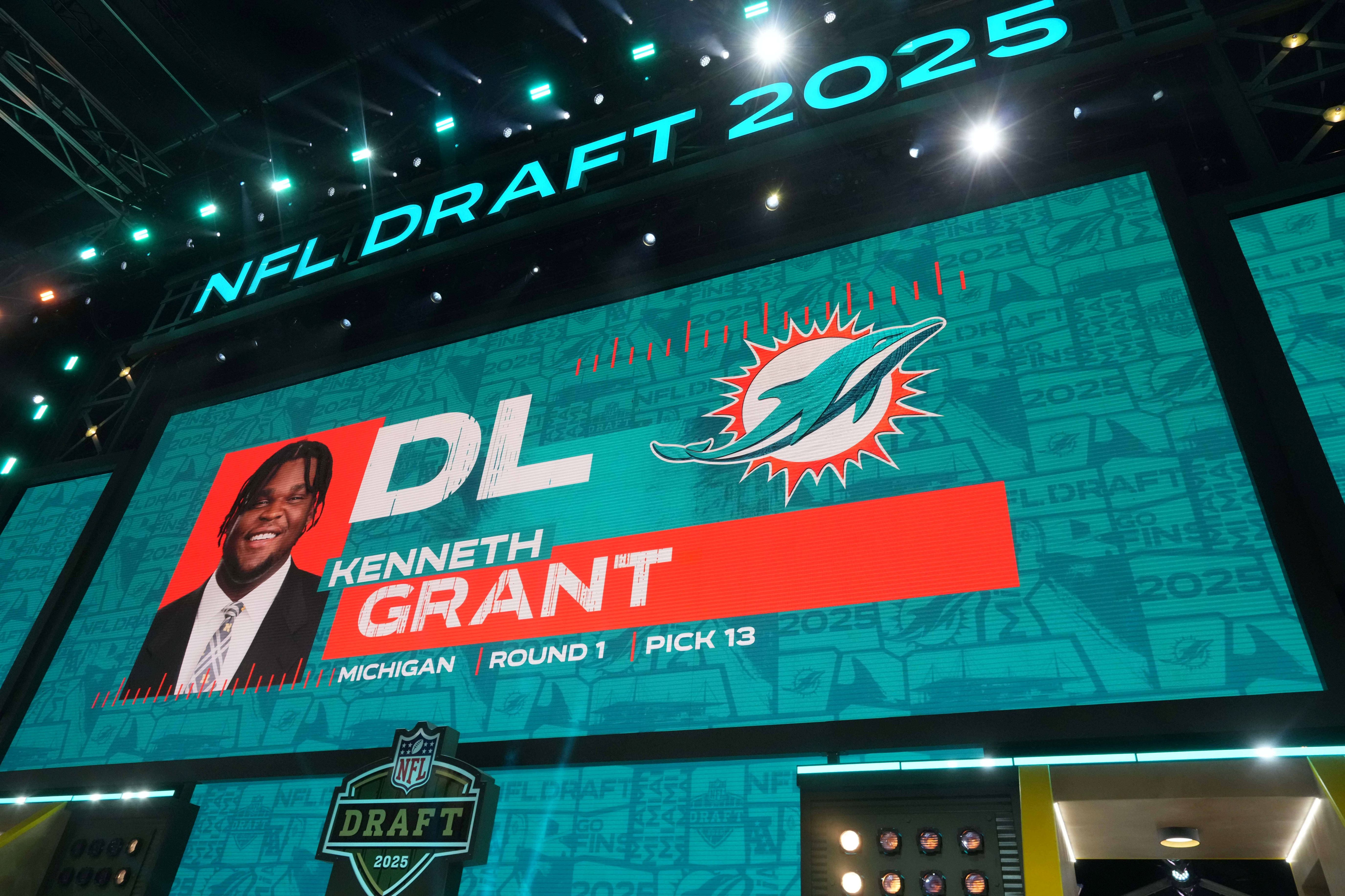 Michigan Wolverines defensive lineman Kenneth Grant is selected as the No. 13 pick by the Miami Dolphins during the NFL Draft at Lambeau Field.