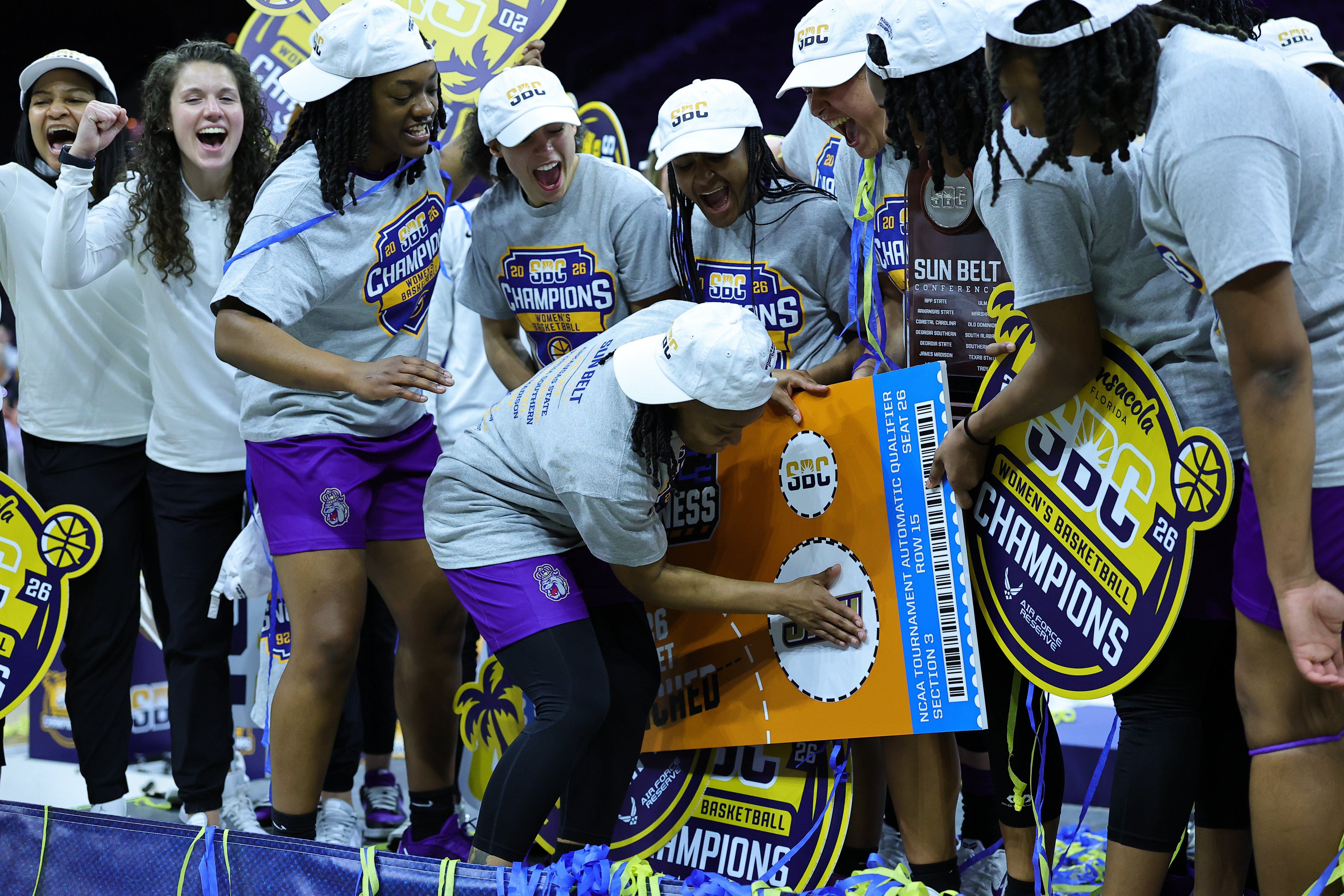 James Madison Dukes guard Zakiya Stephenson (21) slaps the JMU sticker on the March Madness bracket as we look at our printable women's March Madness bracket
