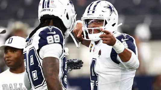 Dallas Cowboys quarterback Dak Prescott - who's featured in our player prop bets for Week 8 - speaks with wide receiver Ceedee Lamb (88).