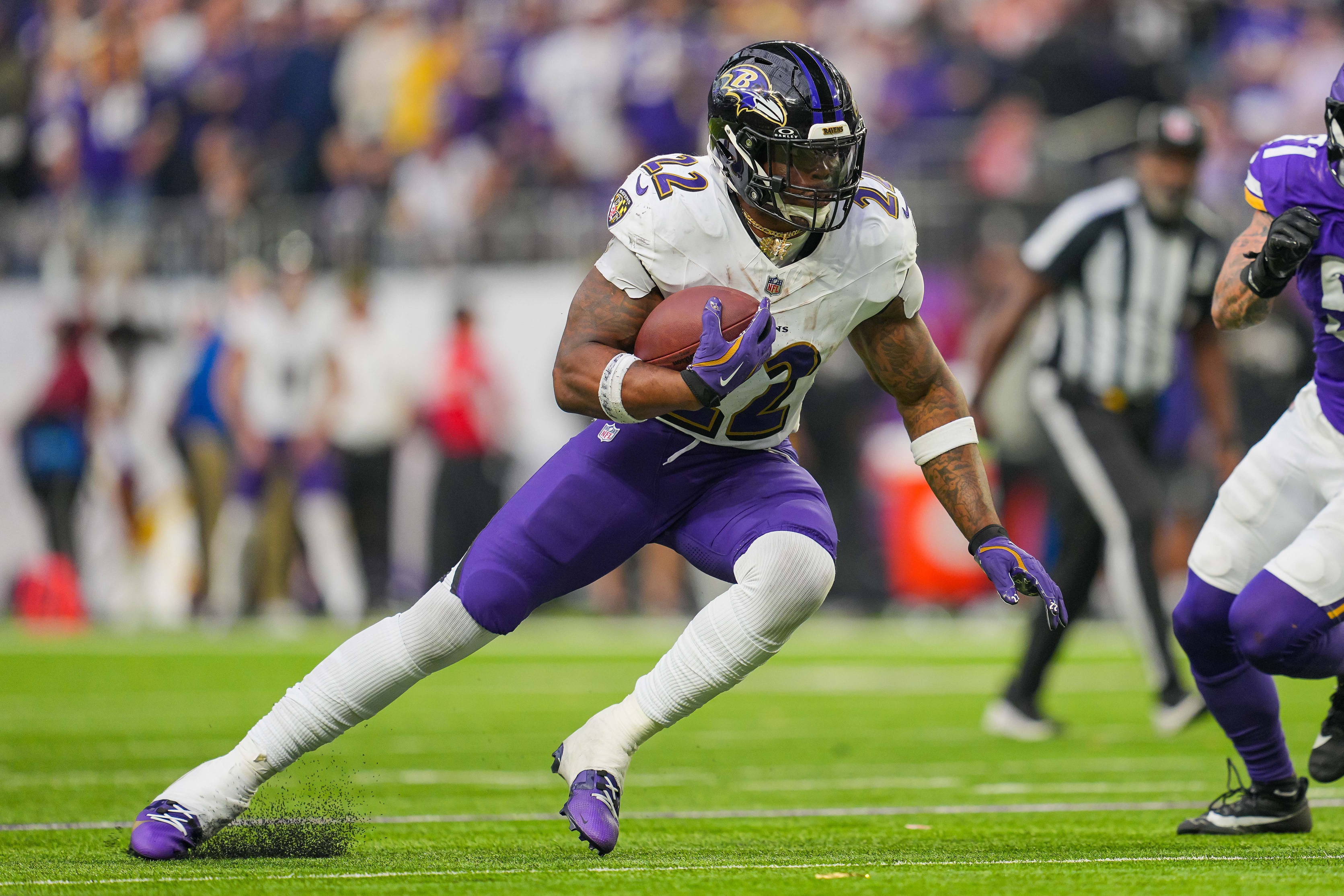 Baltimore Ravens running back Derrick Henry (22) runs with the ball as he is featured in our Ravens vs. Packers player props.