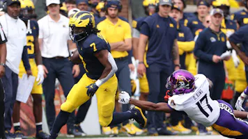 Donovan Edwards of the Michigan Wolverines runs the ball as we share how Michigan sports betting fared in August.