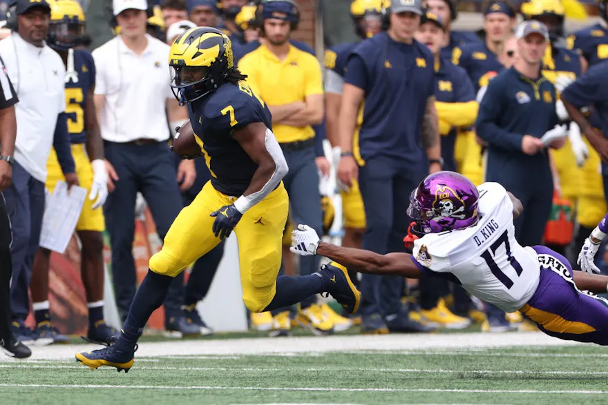 Donovan Edwards of the Michigan Wolverines runs the ball as we share how Michigan sports betting fared in August.