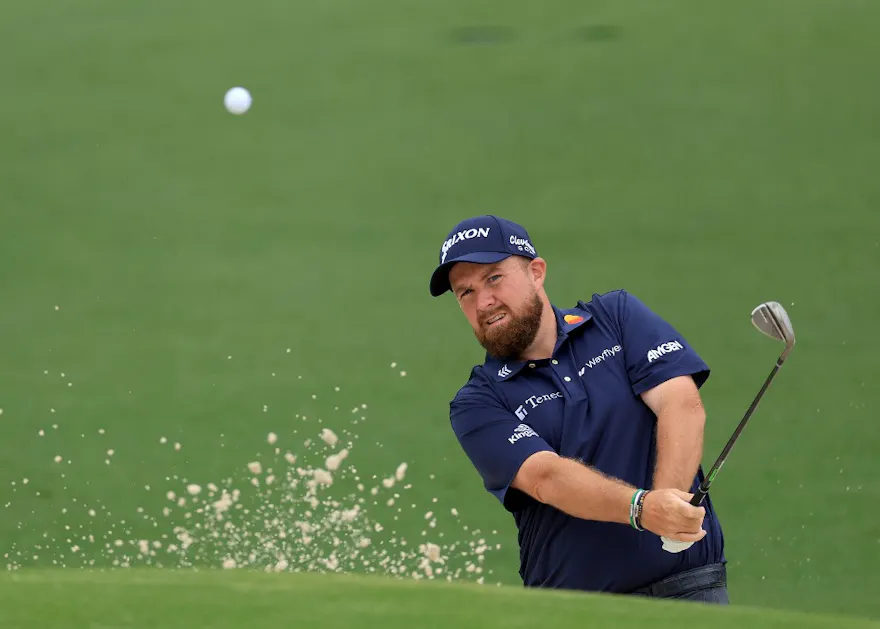 Shane Lowry of Ireland plays a bunker shot during a practice round prior to the 2024 Masters Tournament at Augusta National Golf Club as we offer our best 2024 Masters matchup picks.