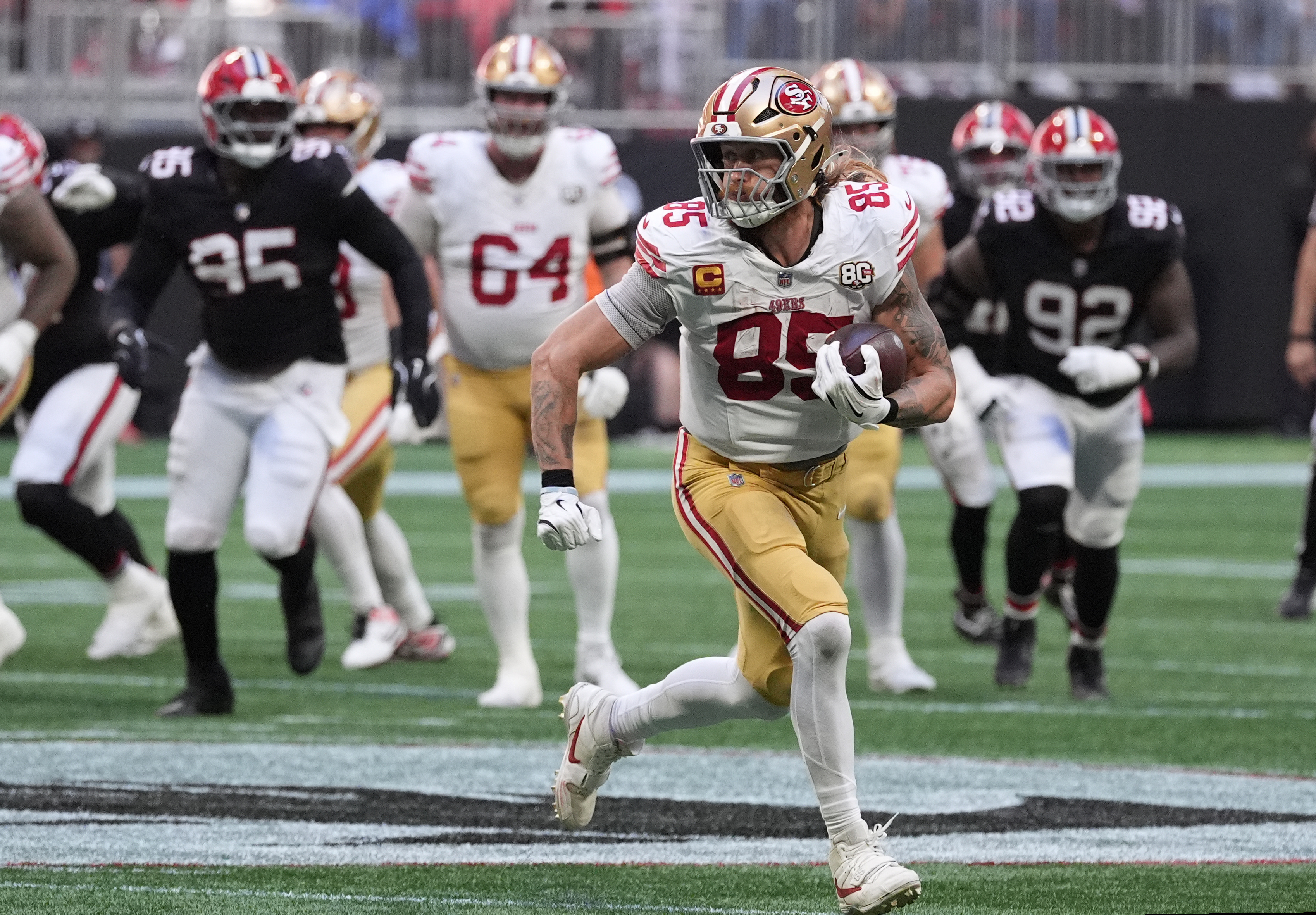 San Francisco 49ers tight end George Kittle (85) runs after a catch as we take a closer look at the NFL Playoff odds. 