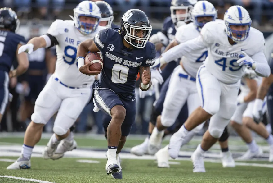 Terrell Vaughn of the Utah State Aggies carries the ball as we share our best Georgia State vs. Utah State prediction.
