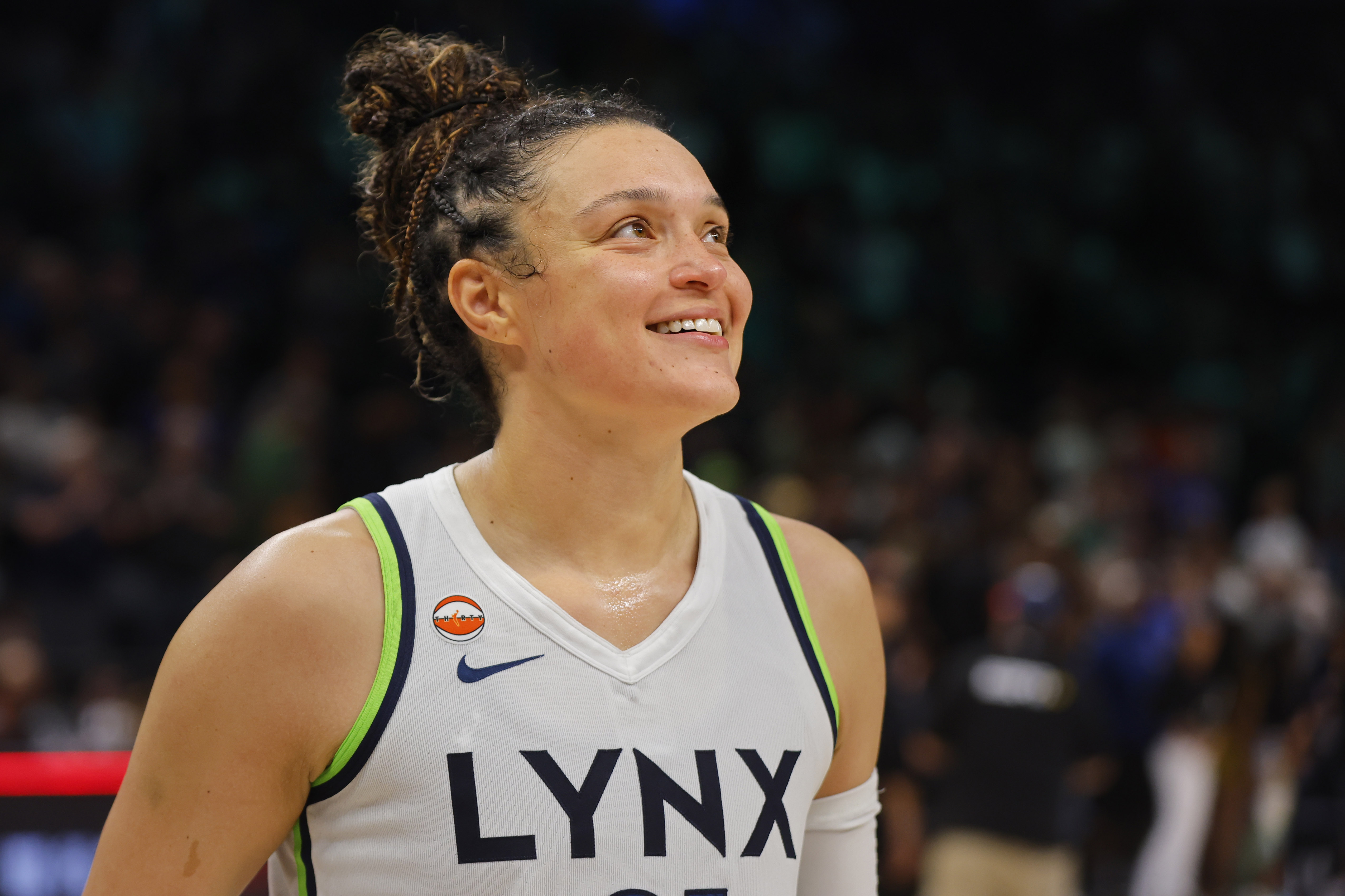 Minnesota Lynx guard Kayla McBride - who's featured in my Mercury vs. Lynx prediction - smiles as she awaits a post-game interview. 