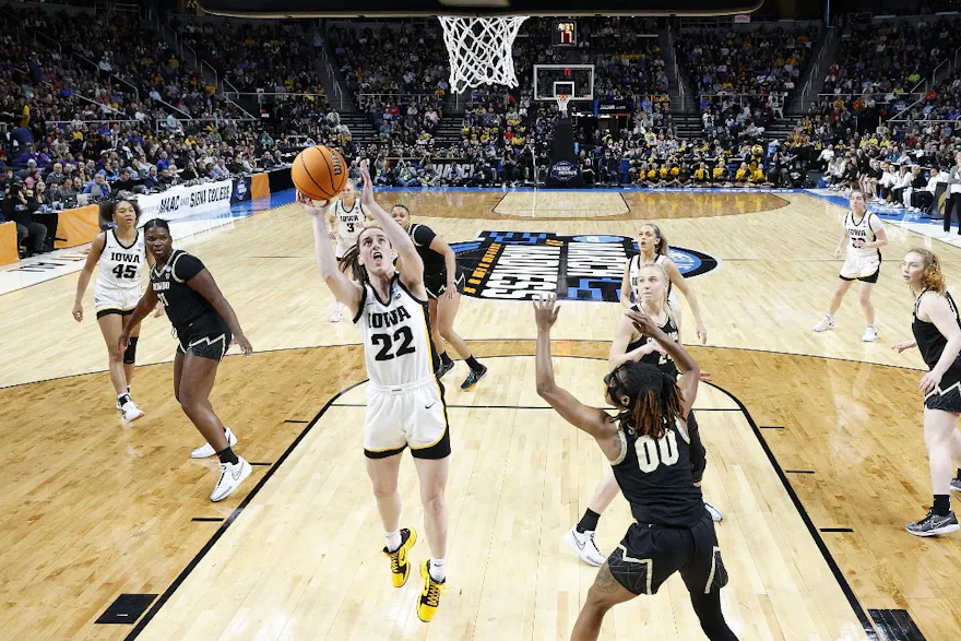 Caitlin Clark of the Iowa Hawkeyes shoots against Jaylyn Sherrod of the Colorado Buffaloes during the Sweet 16 round of the NCAA Women's Basketball Tournament. We expect a high-scoring game in our LSU vs. Iowa prediction & odds. 