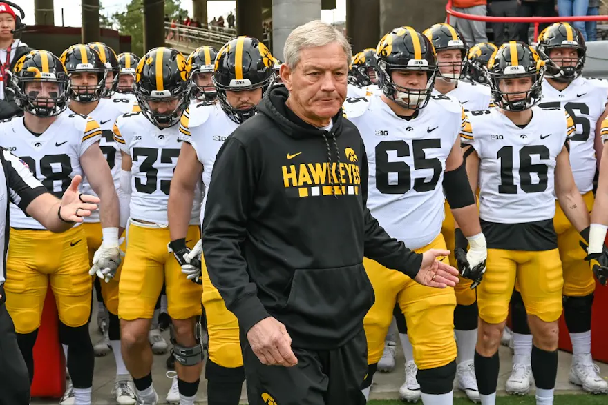 Head coach Kirk Ferentz of the Iowa Hawkeyes leads the team on the field before the game against the Nebraska Cornhuskers as we look at our Iowa-Tennessee prediction.