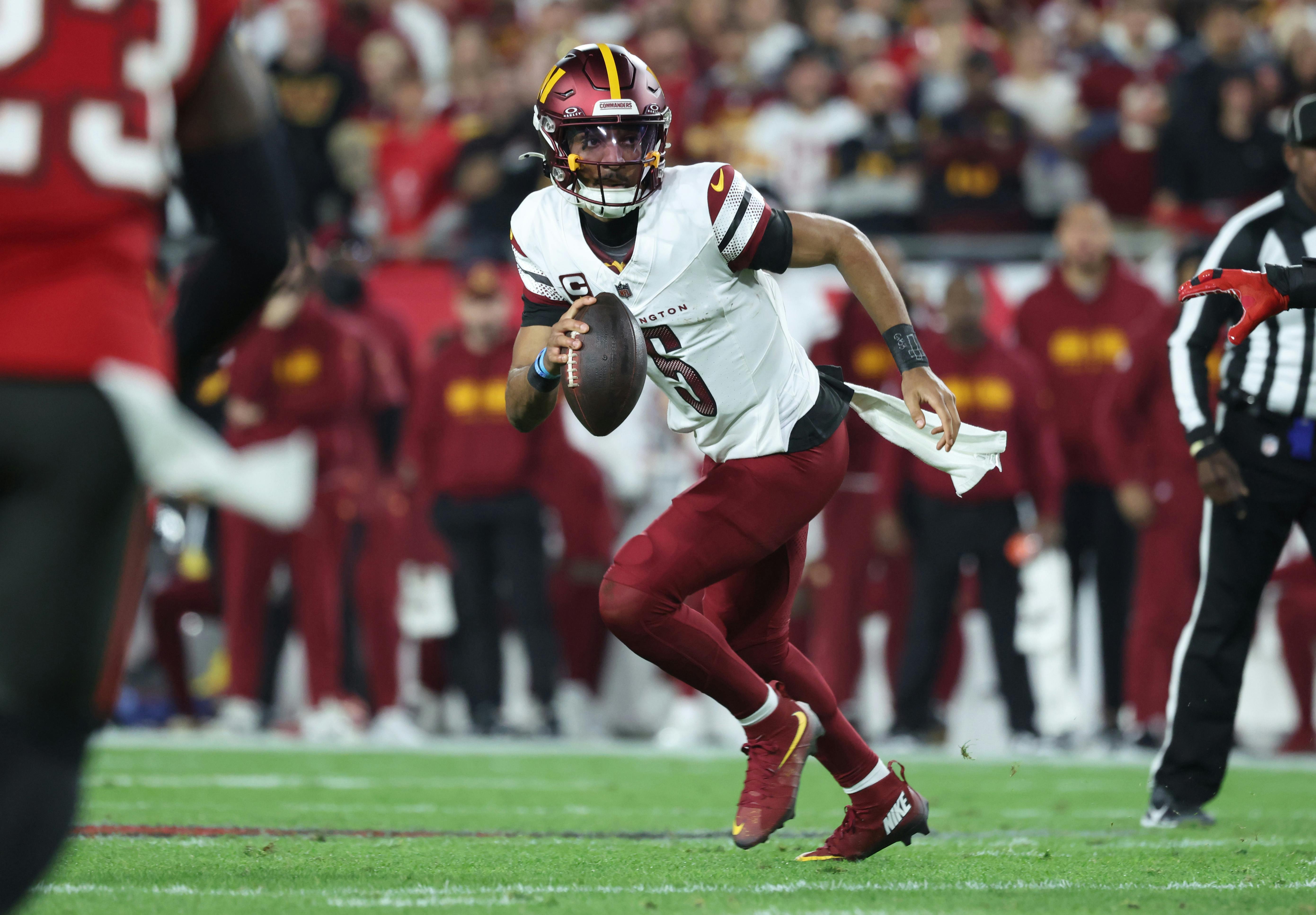 Washington Commanders quarterback Jayden Daniels scrambles as we offer our NFL Divisional Round picks and preview for all four games this weekend.