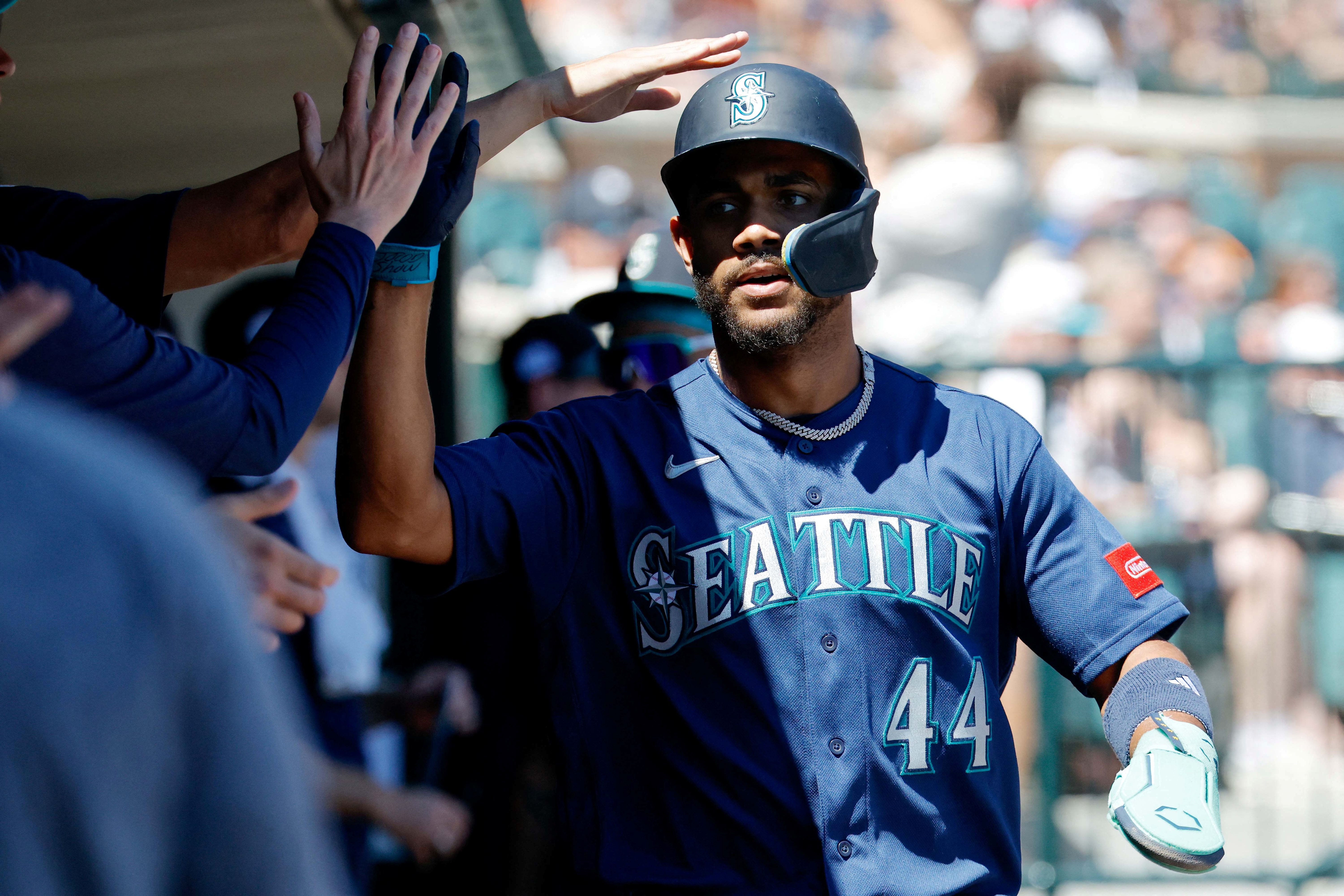 Seattle Mariners center fielder Julio Rodriguez receives congratulations from teammates after scoring, and he's featured in my Mariners vs. Orioles win probability