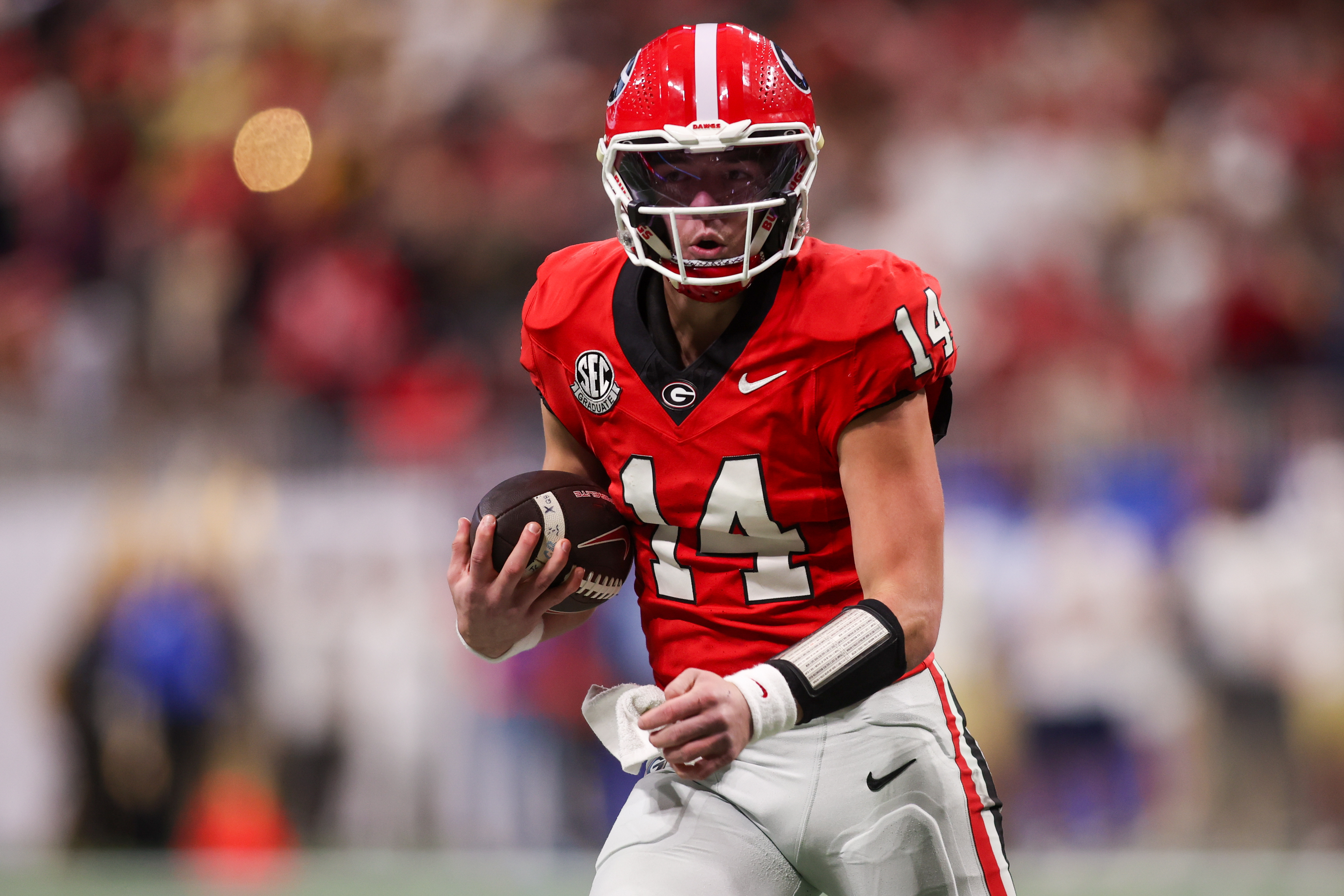 Georgia Bulldogs quarterback Gunner Stockton (14) runs the ball as we break down our Ole Miss vs. Georgia same-game parlay.