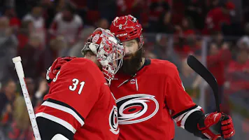 Stefan Noesen #23 of the Carolina Hurricanes reacts with teammate Brent Burns as we take a look at the Stanley Cup 2024 odds. 