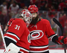 Stefan Noesen #23 of the Carolina Hurricanes reacts with teammate Brent Burns as we take a look at the Stanley Cup 2024 odds. 