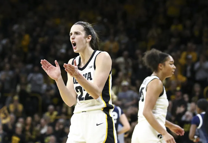 Guard Caitlin Clark #22 of the Iowa Hawkeyes celebrates as we make our Iowa vs. Nebraska prediction and pick for Sunday's matchup, with Clark closing in on the all-time career scoring record.