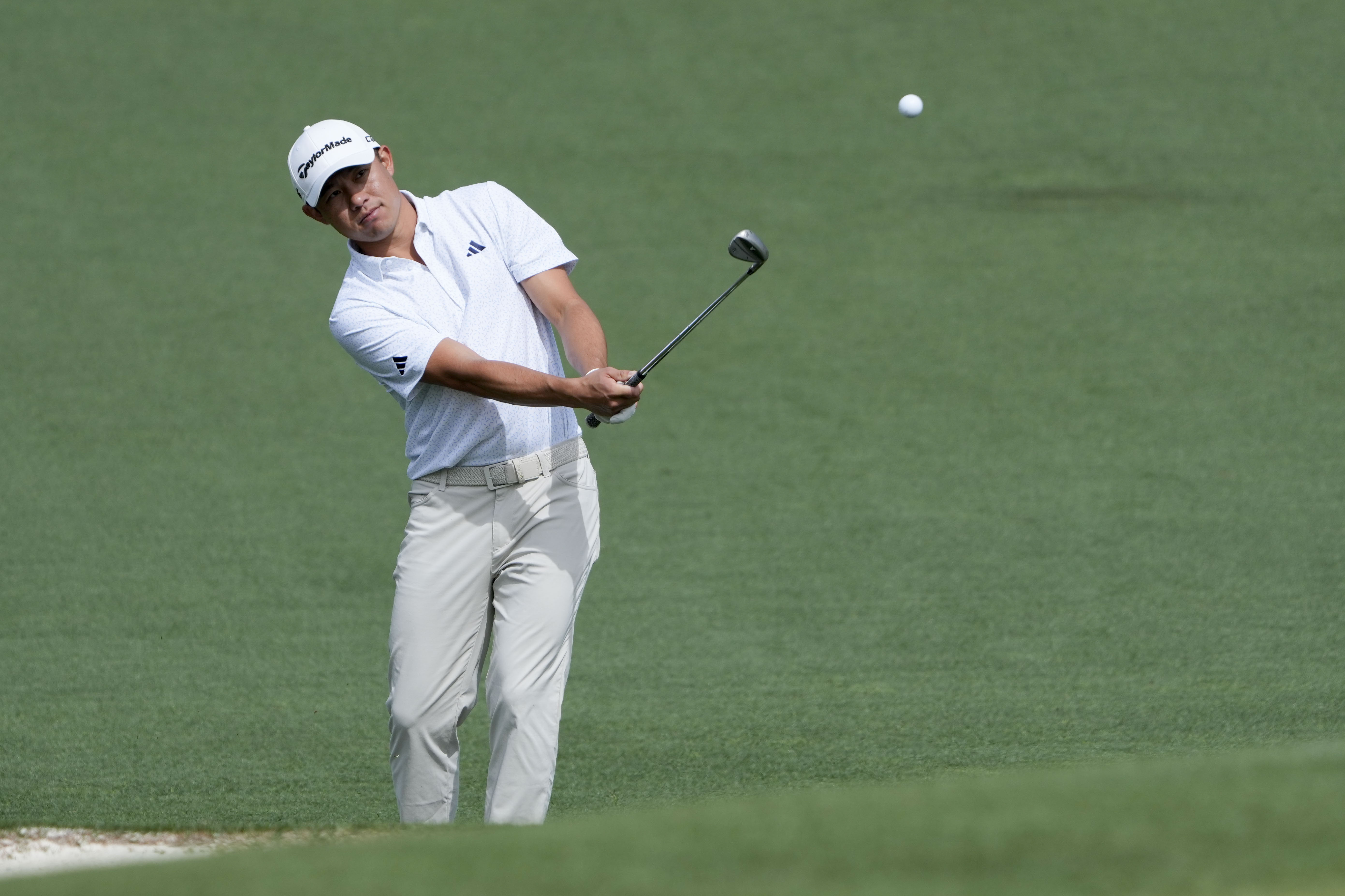 Collin Morikawa chips onto the no. 2 green during a practice round for the Masters Tournament at Augusta National Golf Club.