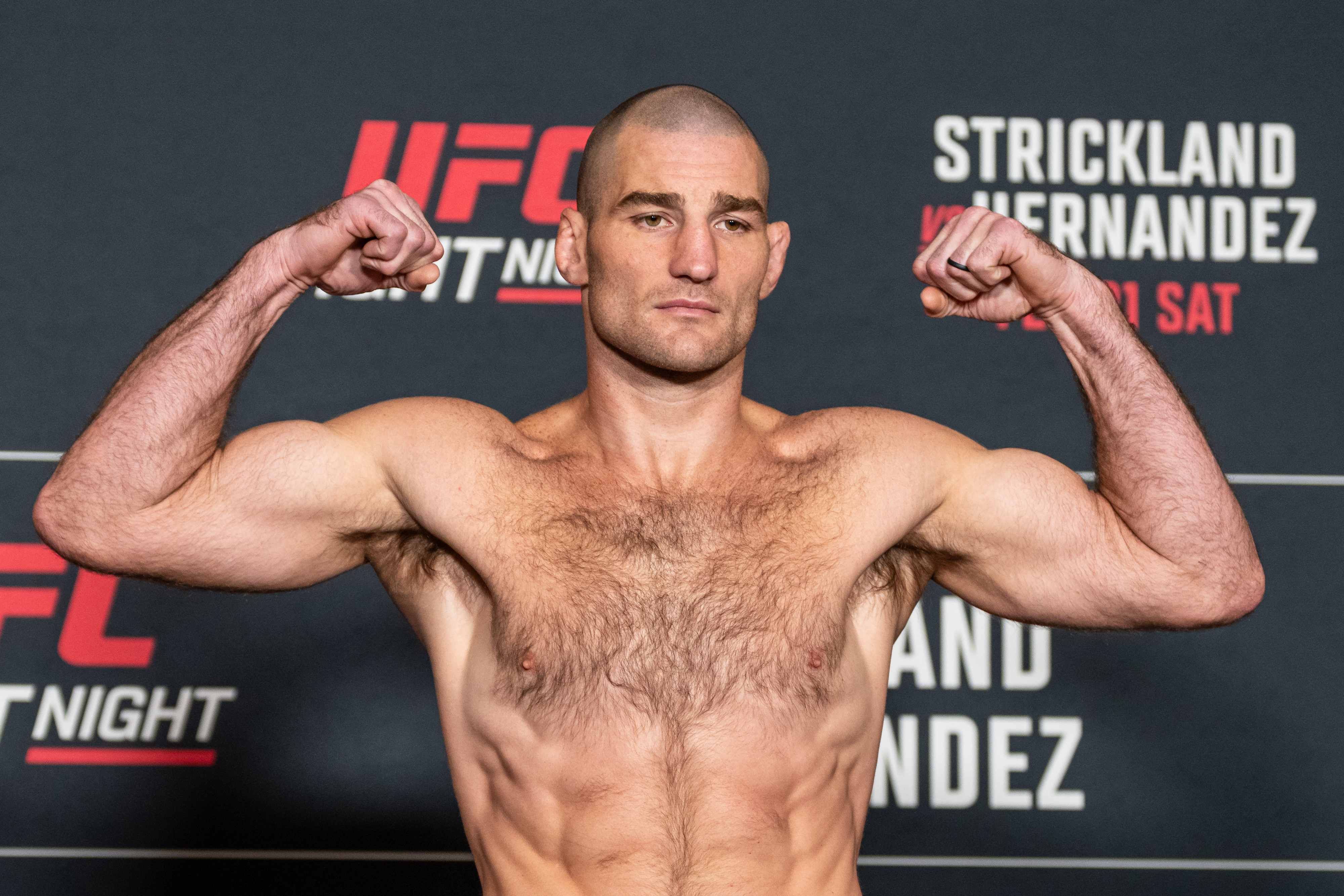 Fighter Sean Strickland, seen here stepping on a scale, is featured in our UFC Fight Night odds.