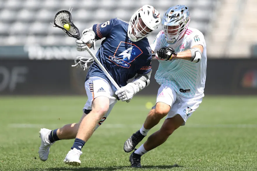 Tom Schreiber of the Archers LC brings the ball out from behind the net. Photo by Matthew Stockman/Getty Images via AFP.