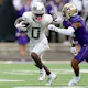 Bucky Irving #0 of the Oregon Ducks carries the ball against Jabbar Muhammad #1 of the Washington Huskies as we make our Oregon vs. Washington Pac-12 Championship player props picks and predictions.